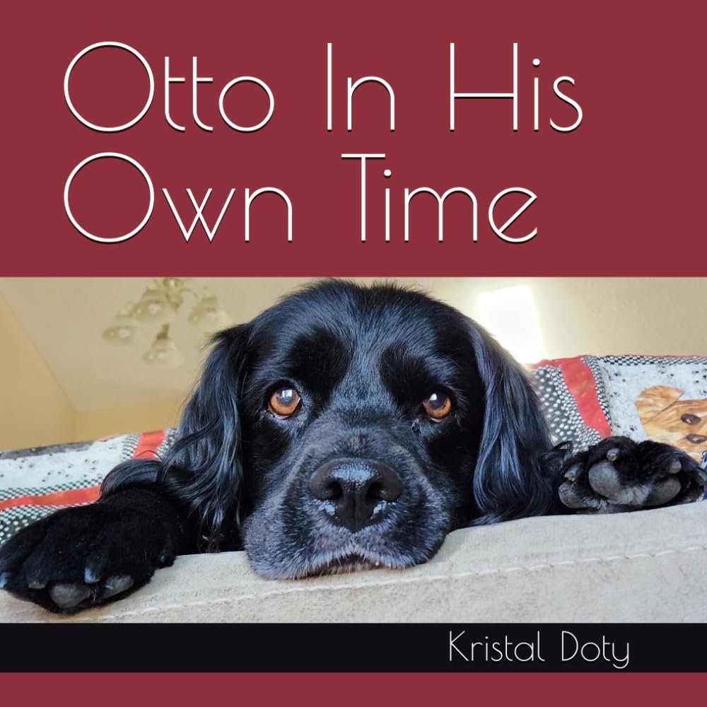 Otto In His Own Time book cover, author Kristal Doty. Image of a black cocker spaniel peeking over the edge of the couch, face between his paws.